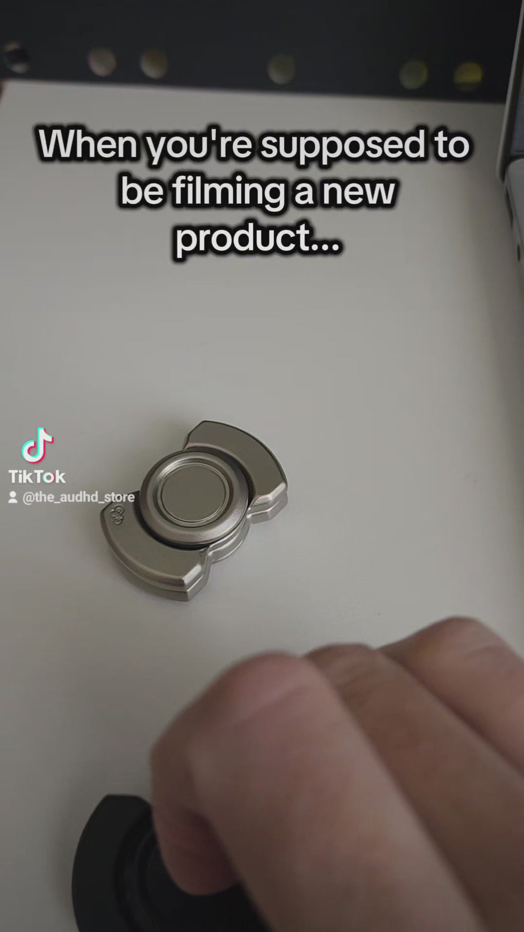 video of 2 metal fidgets interacting with one another on a white background
